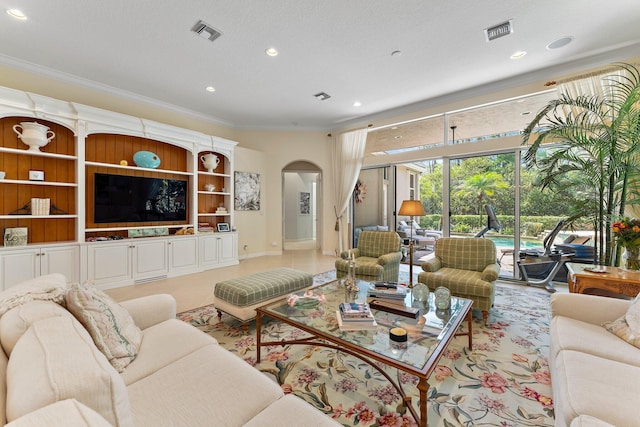 living room with a textured ceiling and crown molding