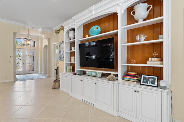 tiled living room with french doors and crown molding