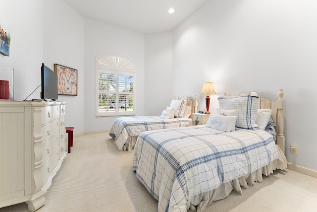 carpeted bedroom with high vaulted ceiling