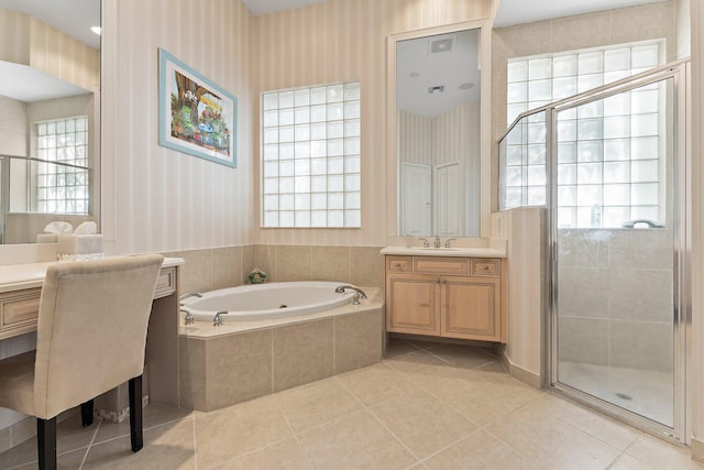 bathroom featuring tile patterned floors, vanity, independent shower and bath, and a healthy amount of sunlight