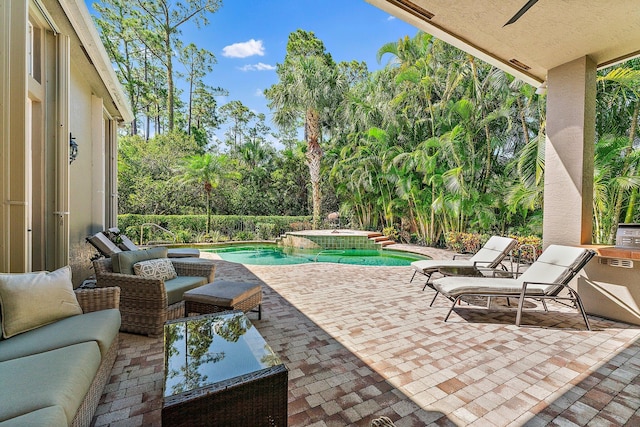 view of patio / terrace featuring a pool with hot tub and an outdoor living space