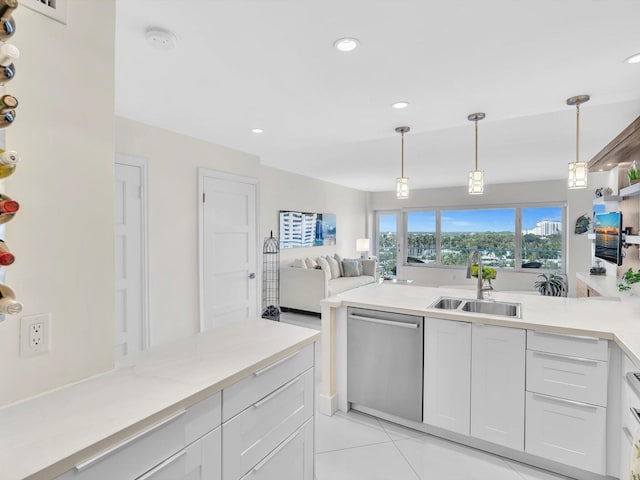 kitchen featuring sink, stainless steel dishwasher, decorative light fixtures, light tile patterned flooring, and white cabinetry