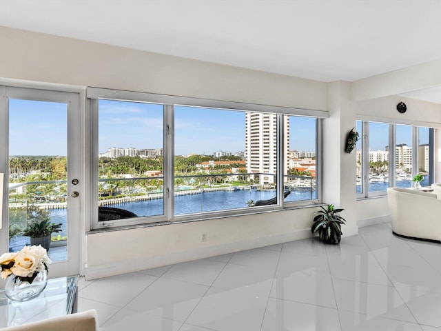 sunroom featuring a wealth of natural light and a water view