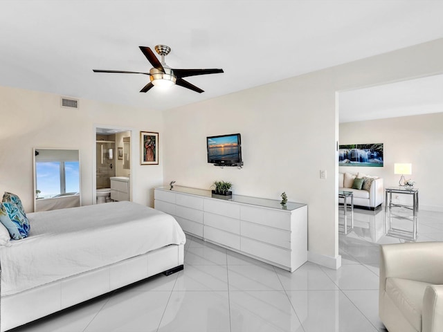 tiled bedroom featuring ceiling fan and ensuite bathroom