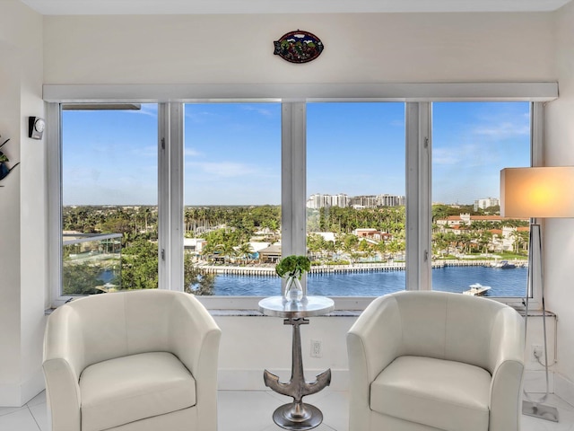 living area featuring a water view and a healthy amount of sunlight