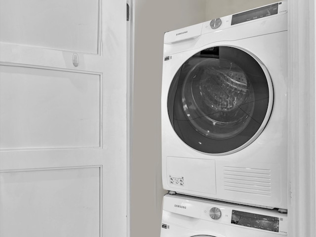 clothes washing area featuring stacked washer / drying machine