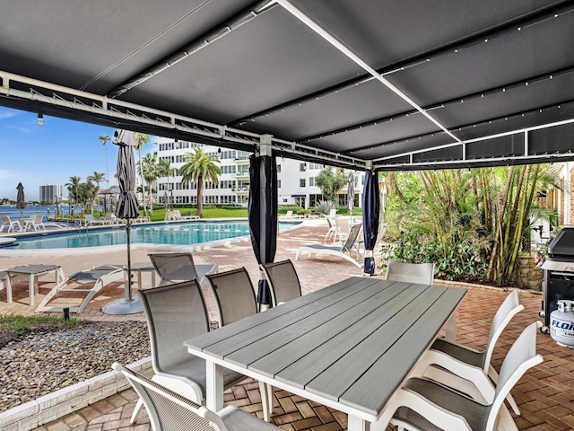 view of patio featuring area for grilling and a community pool