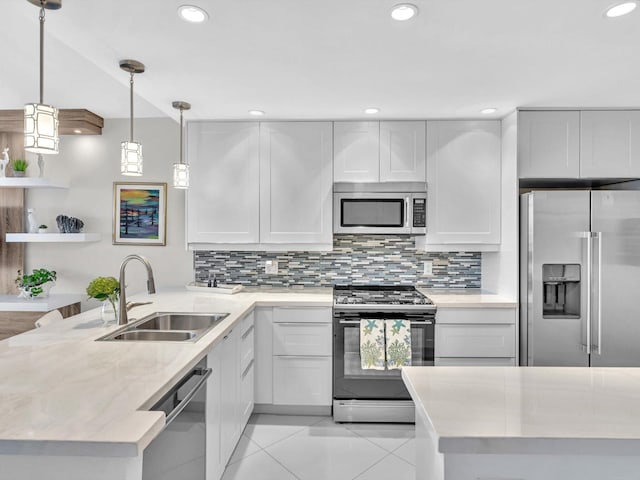 kitchen with white cabinetry, sink, pendant lighting, and appliances with stainless steel finishes