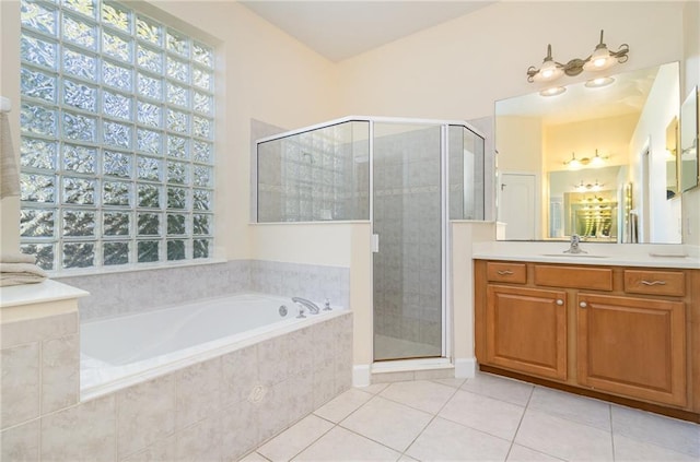 bathroom featuring plus walk in shower, tile patterned flooring, and vanity