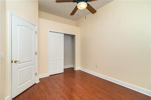 unfurnished bedroom with ceiling fan, dark hardwood / wood-style floors, and a closet