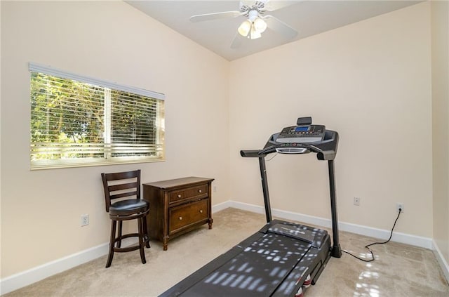 workout area featuring ceiling fan and light carpet