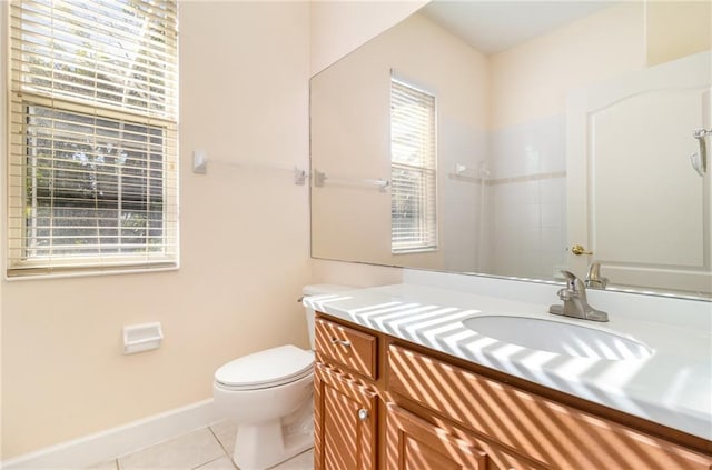 bathroom with tile patterned flooring, vanity, and toilet