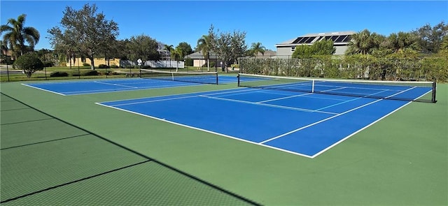 view of tennis court featuring basketball hoop