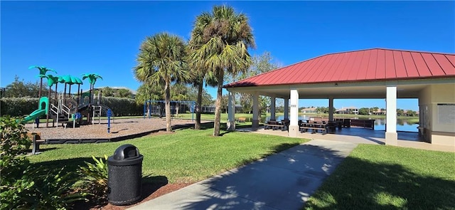 view of property's community featuring a gazebo, a water view, a playground, and a yard