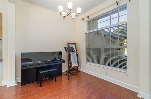 misc room with hardwood / wood-style floors and a chandelier