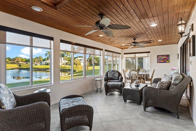 sunroom featuring a water view, ceiling fan, and wooden ceiling