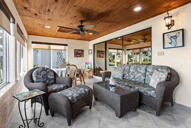 sunroom featuring ceiling fan and wooden ceiling