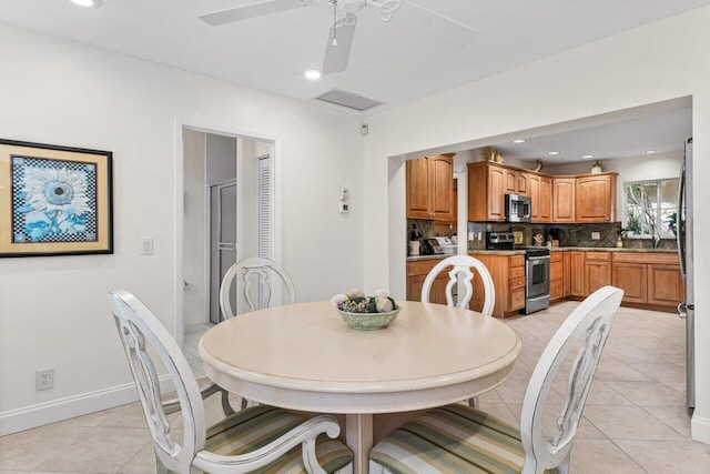 tiled dining area featuring ceiling fan