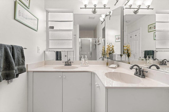 bathroom with vanity, an enclosed shower, and a healthy amount of sunlight