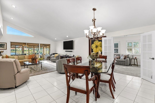 tiled dining room featuring a chandelier, high vaulted ceiling, and plenty of natural light