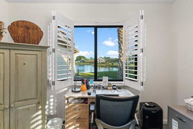 office area with a healthy amount of sunlight and a water view