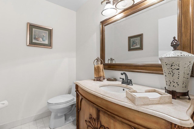 bathroom with tile patterned floors, vanity, and toilet