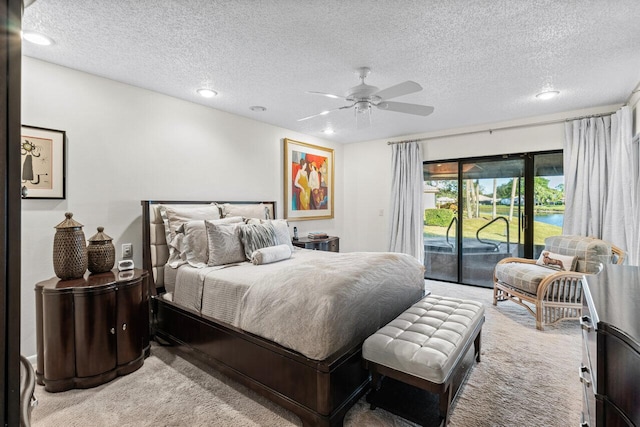 carpeted bedroom featuring access to exterior, ceiling fan, and a textured ceiling