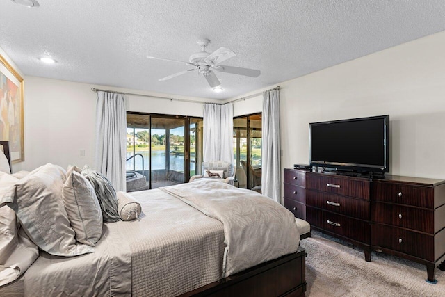 bedroom featuring access to outside, ceiling fan, light carpet, and a textured ceiling