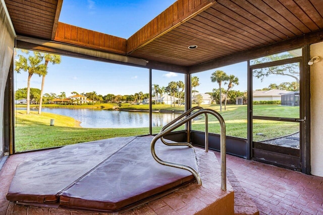 unfurnished sunroom with a water view and wood ceiling