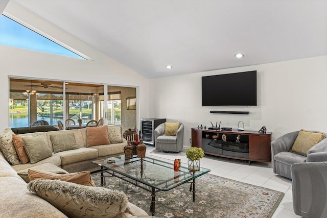 living room with a water view, light tile patterned floors, and high vaulted ceiling