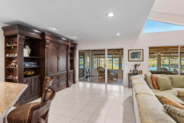 living room featuring a water view, a wealth of natural light, and ceiling fan