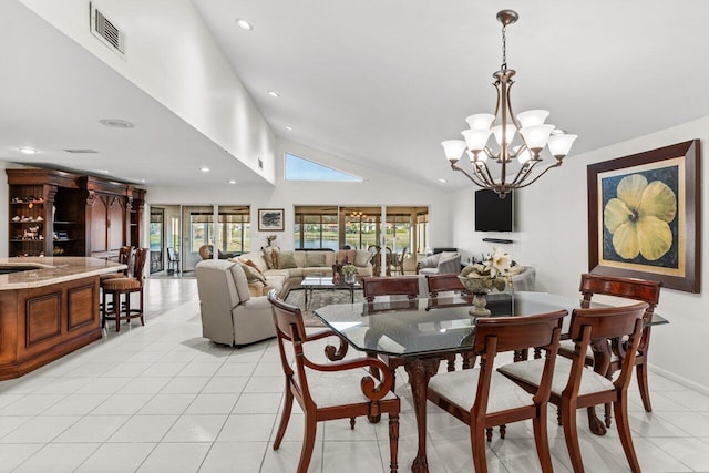 tiled dining room with a notable chandelier and high vaulted ceiling