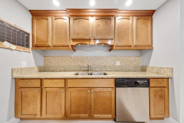 kitchen with stainless steel dishwasher, decorative backsplash, light stone countertops, and sink