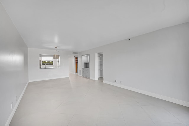 unfurnished living room featuring light tile patterned floors