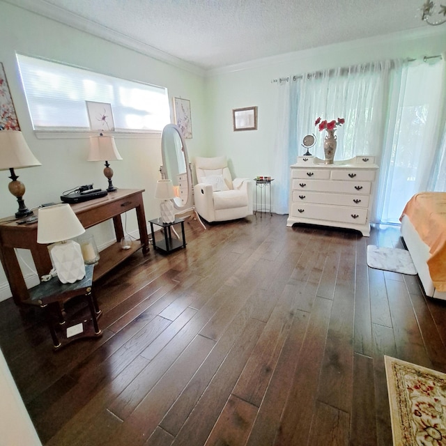 sitting room with a textured ceiling, dark hardwood / wood-style floors, and crown molding