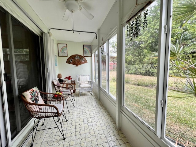 sunroom / solarium featuring ceiling fan