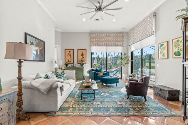 living room with crown molding, ceiling fan, and a high ceiling