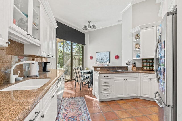 kitchen with white cabinets, appliances with stainless steel finishes, ornamental molding, and sink