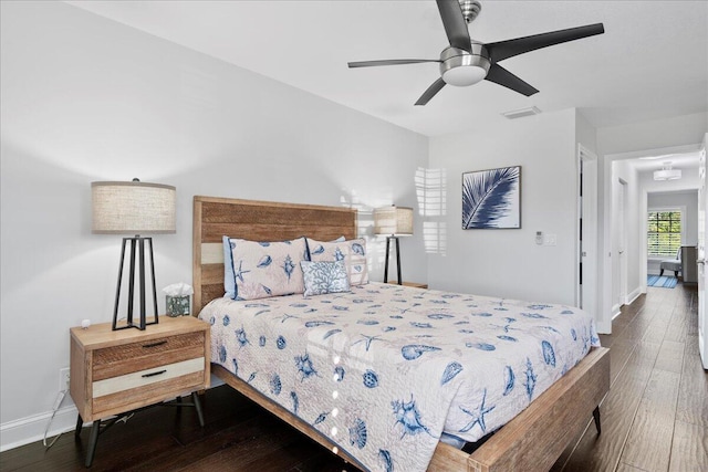 bedroom with ceiling fan and dark hardwood / wood-style flooring