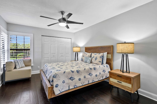 bedroom with ceiling fan, a closet, and dark wood-type flooring