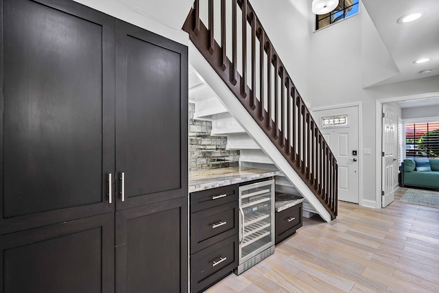 interior space with beverage cooler and wood-type flooring