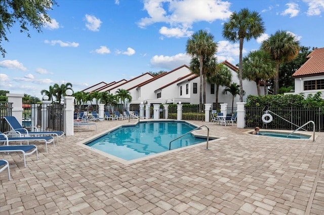 view of pool featuring a patio area and a hot tub