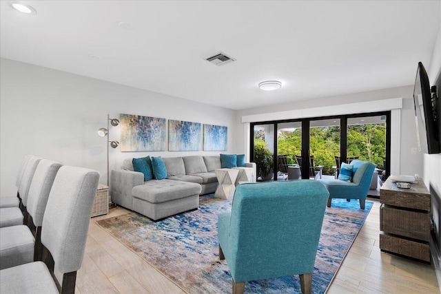 living room with light hardwood / wood-style floors and french doors