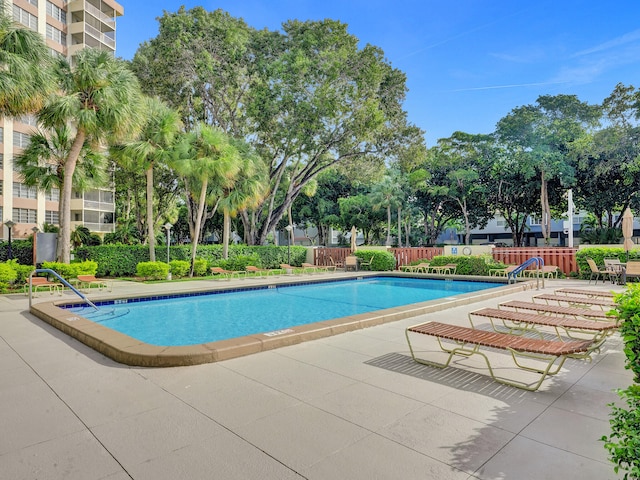 view of swimming pool with a patio