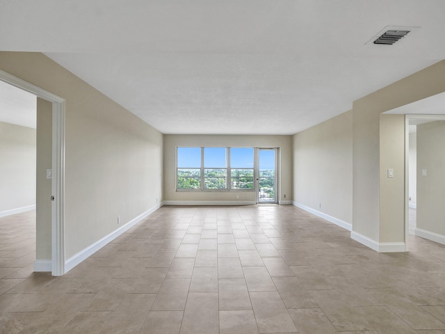 spare room featuring light tile patterned flooring