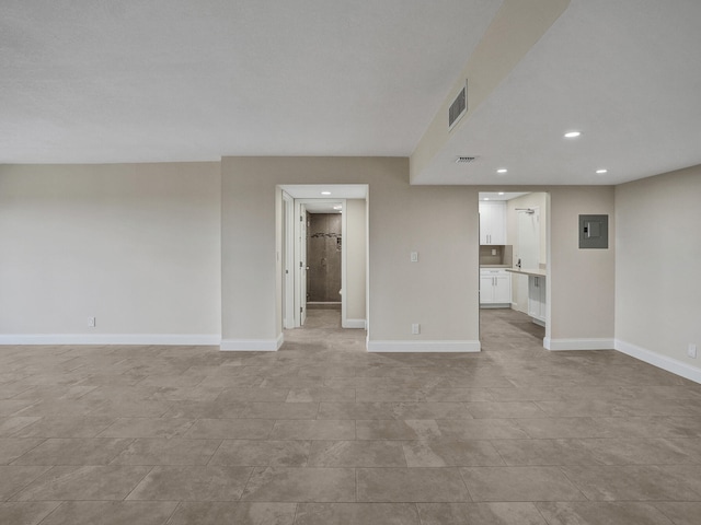 unfurnished living room with electric panel