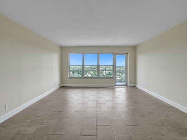 spare room featuring light tile patterned floors