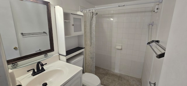 bathroom with a shower with curtain, vanity, toilet, and tile patterned floors