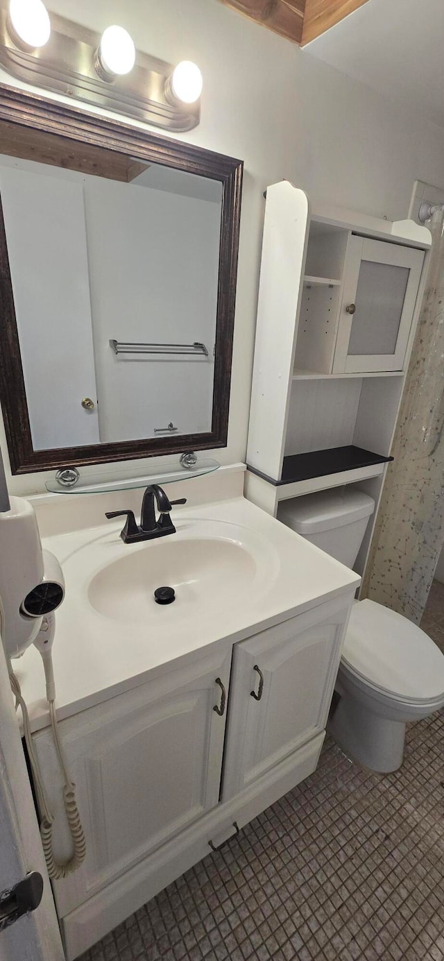 bathroom with tile patterned floors, vanity, and toilet