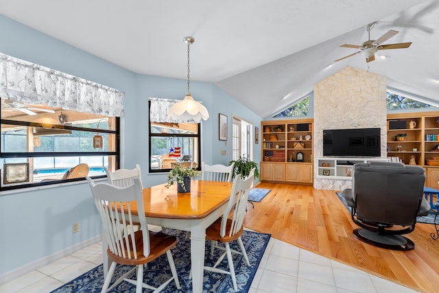 dining room with built in shelves, light wood-type flooring, ceiling fan, and lofted ceiling